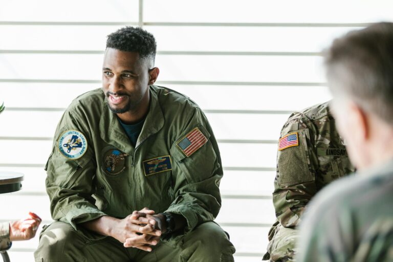 Counseling session with military veterans in uniform focused on healing and recovery.
