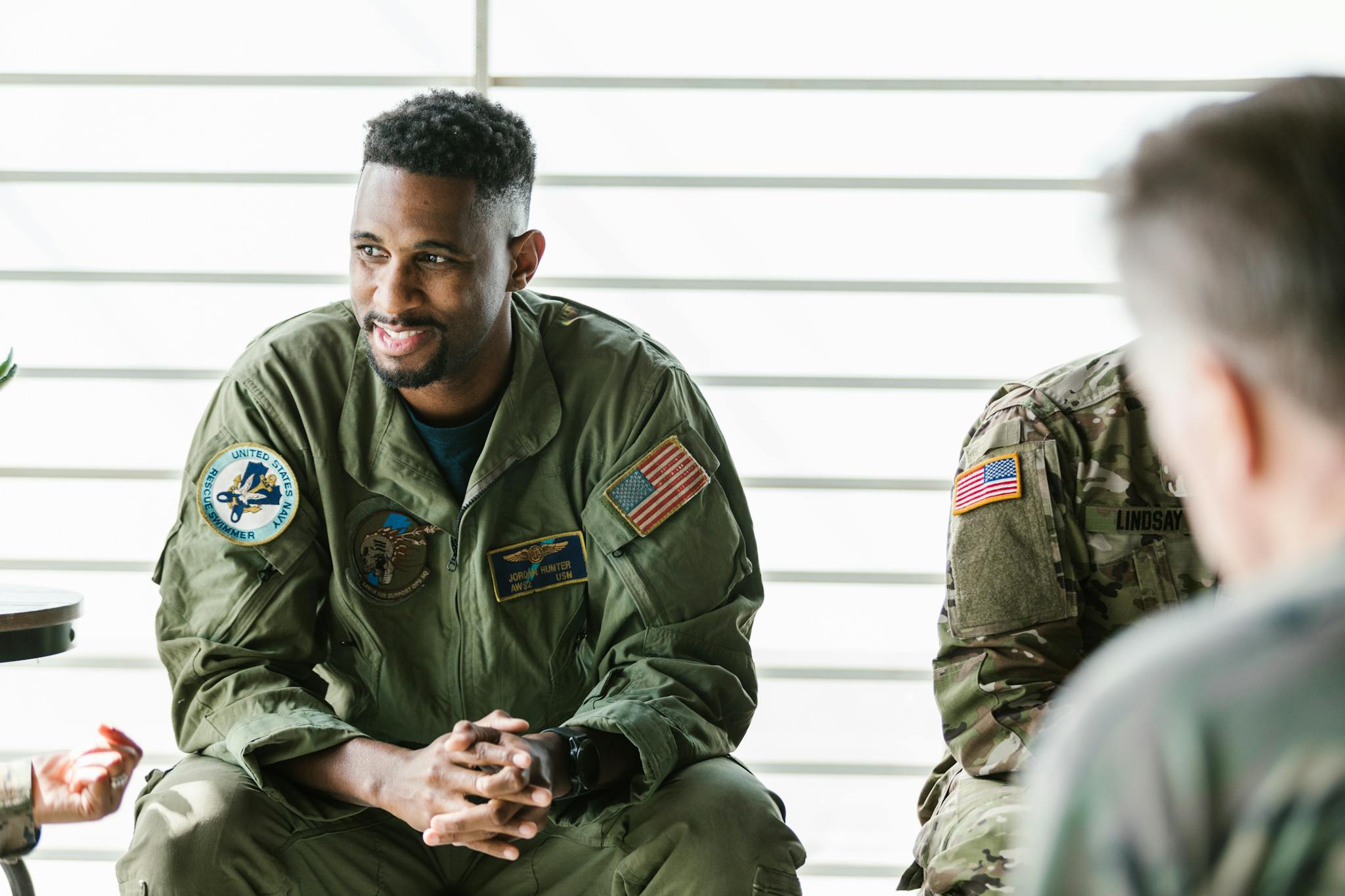 Counseling session with military veterans in uniform focused on healing and recovery.