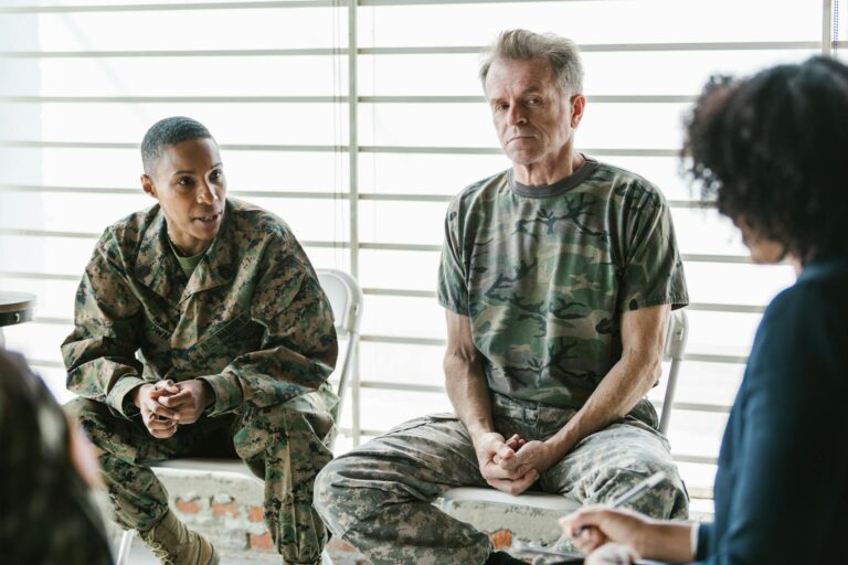 Military personnel discuss mental health in a supportive group therapy session.
